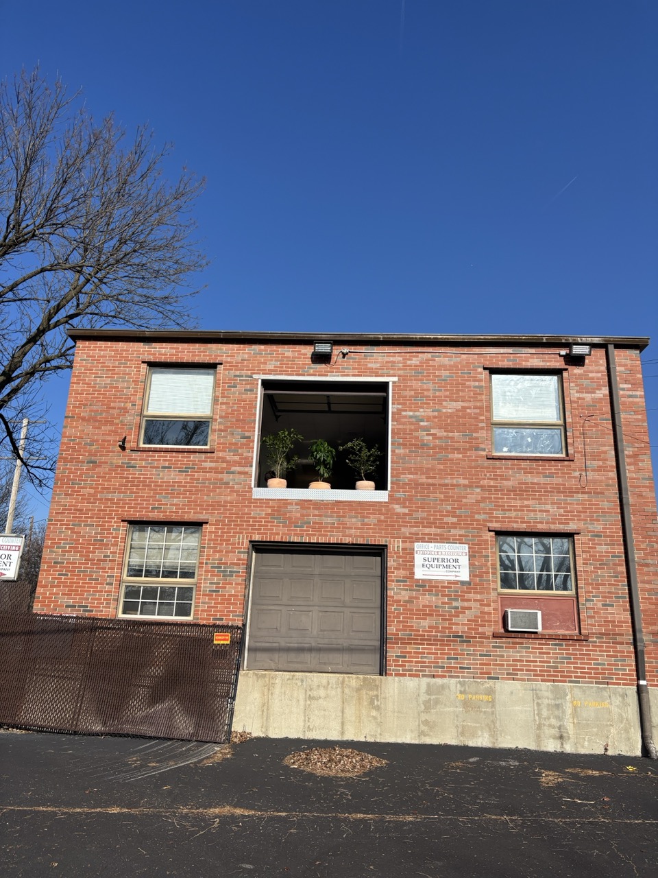 Ren AI Lab building exterior showing brick facade and signature garage door window